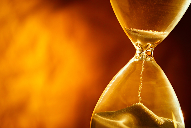 Sand passing through the bulbs of an hourglass