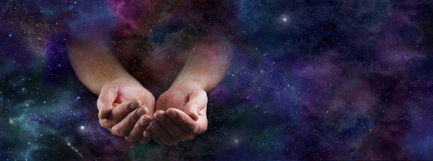 Our Abundant Universe - Male hands emerging from a wide dark dee