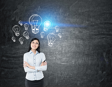 Girl with black hair near blackboard with blue light bulbs