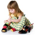 Little girl try on big shoes