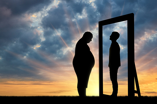 Fat sad man and his reflection in the mirror of a normal man against sky.