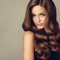 Beautiful model girl with long wavy and shiny hair . Brunette wo