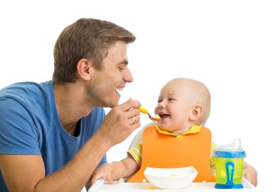 smiling baby eating food