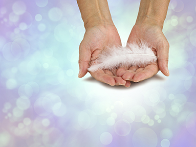 A message from your angel - female hands gently holding a fluffy