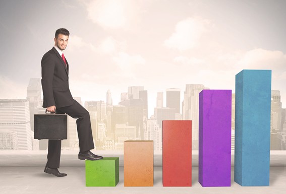 Business person climbing up on colourful chart pillars concept