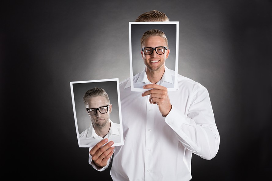 Man Holding Happy Picture In Front Of His Face