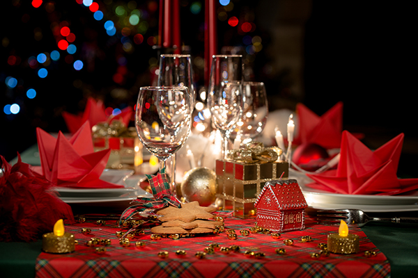 red and golden christmas table decoration with dim light candle