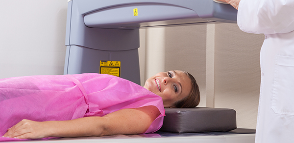 Woman in 40s undergoing open mri with doctor supervising