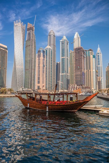 Dubai Marina with boats against skyscrapers in Dubai, United Ara