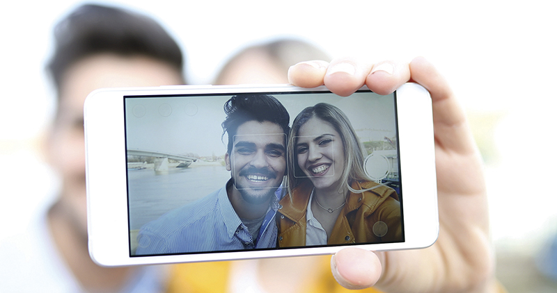 Couple in love taking selfies outdoors