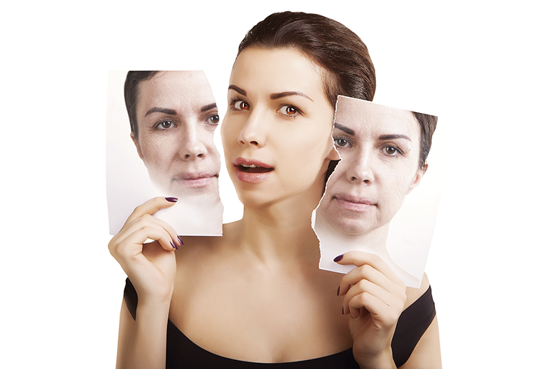 young woman breaks her portrait with old skin