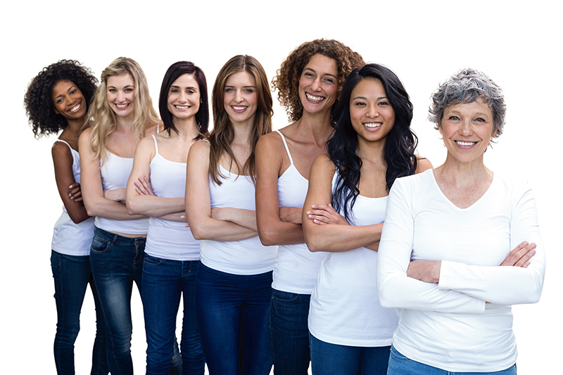 Happy multiethnic women standing in a line with hands crossed