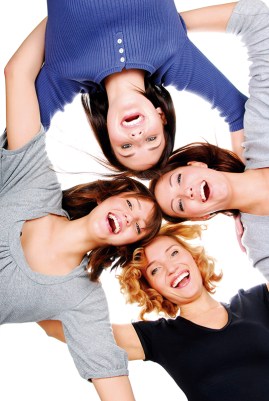 Group of four young adult happy girls