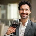 Man tasting a glass of red wine in a restaurant