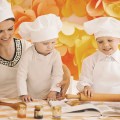 happy mother with children preparing dinner in the kitchen