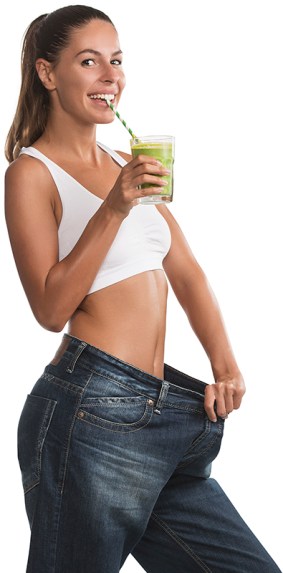 Fit, beautiful, young woman in oversize pants holding a healthy,