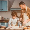 Kid and dad making dish for dessert