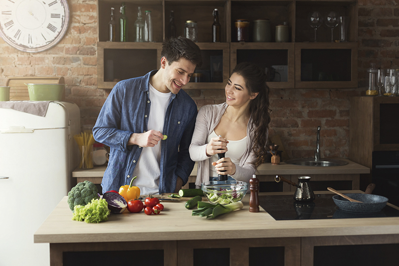 Happy couple cooking healthy food together
