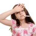 sick child with hand on forehead