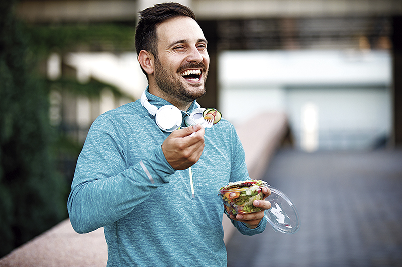 Man is eating vegetable salad